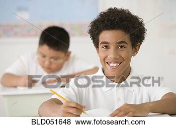 Stock Photo - hispanic boy writing 
at school desk. 
fotosearch - search 
stock photos, 
pictures, images, 
and photo clipart