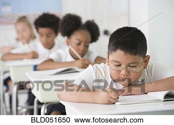 Stock Photography - hispanic boy writing 
at school desk. 
fotosearch - search 
stock photos, 
pictures, images, 
and photo clipart