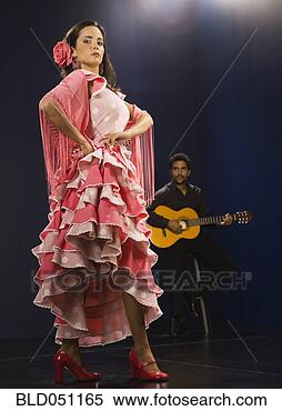 Stock Image - hispanic female 
flamenco dancer 
with guitar player 
in background. 
fotosearch - search 
stock photos, 
pictures, images, 
and photo clipart