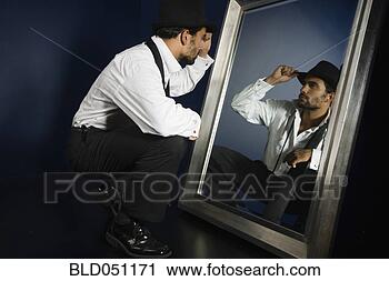 Stock Photography - hispanic man in 
suit looking in 
mirror. fotosearch 
- search stock 
photos, pictures, 
images, and photo 
clipart