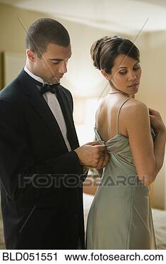 Stock Photography - hispanic man zipping 
up wife’s dress. 
fotosearch - search 
stock photos, 
pictures, images, 
and photo clipart