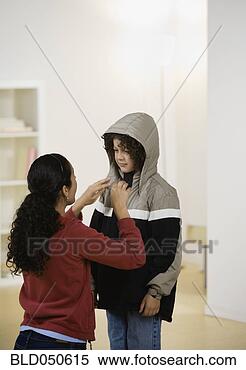 Stock Image - hispanic mother 
fastening son’s 
jacket. fotosearch 
- search stock 
photos, pictures, 
images, and photo 
clipart