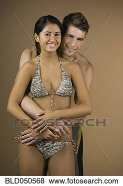 Stock Photo - multi-ethnic couple 
hugging in bathing 
suits. fotosearch 
- search stock 
photos, pictures, 
images, and photo 
clipart