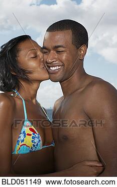 Stock Photograph - multi-ethnic couple 
kissing. fotosearch 
- search stock 
photos, pictures, 
images, and photo 
clipart