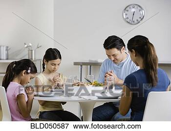 Picture - multi-ethnic family 
praying at dinner 
table. fotosearch 
- search stock 
photos, pictures, 
images, and photo 
clipart