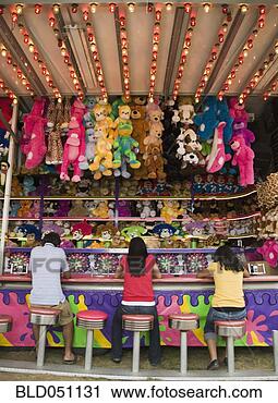 Stock Photography - multi-ethnic teenaged 
friends playing 
carnival game. 
fotosearch - search 
stock photos, 
pictures, images, 
and photo clipart