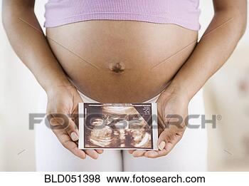 Stock Photo - pregnant african 
american woman 
holding ultrasound 
printout. fotosearch 
- search stock 
photos, pictures, 
images, and photo 
clipart