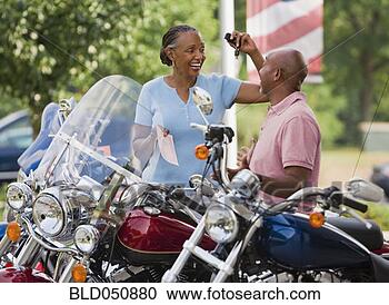 Stock Photography - senior african 
american couple 
buying motorcycle. 
fotosearch - search 
stock photos, 
pictures, images, 
and photo clipart