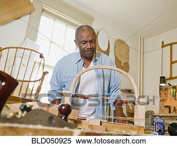 Stock Image - senior african 
american man in 
woodworking shop. 
fotosearch - search 
stock photos, 
pictures, images, 
and photo clipart