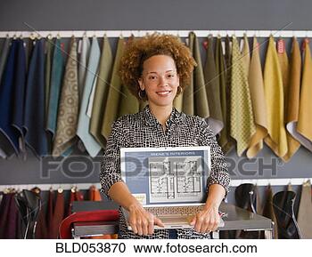 Stock Photography - african female 
interior designer 
holding laptop. 
fotosearch - search 
stock photos, 
pictures, images, 
and photo clipart