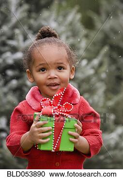 Stock Photography - african girl holding 
christmas gift. 
fotosearch - search 
stock photos, 
pictures, images, 
and photo clipart