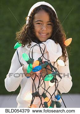 Stock Photograph - african girl holding 
christmas lights. 
fotosearch - search 
stock photos, 
pictures, images, 
and photo clipart