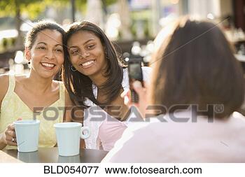 Picture - african mother 
and daughter having 
photograph taken. 
fotosearch - search 
stock photos, 
pictures, images, 
and photo clipart