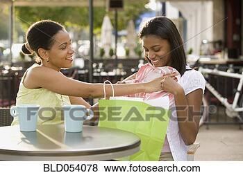 Stock Photo - african mother 
holding new clothes 
up to daughter. 
fotosearch - search 
stock photos, 
pictures, images, 
and photo clipart