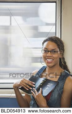Stock Photo - african woman 
holding bible. 
fotosearch - search 
stock photos, 
pictures, images, 
and photo clipart