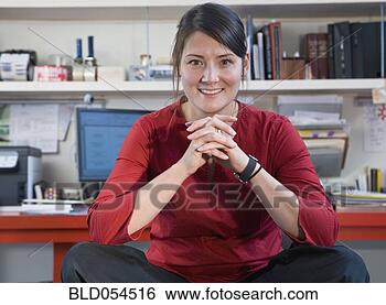 Stock Photo - asian woman sitting 
in home office. 
fotosearch - search 
stock photos, 
pictures, images, 
and photo clipart