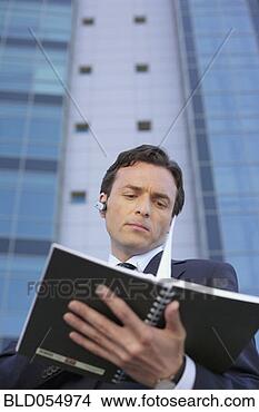 Stock Photo - businessman looking 
at day planner. 
fotosearch - search 
stock photos, 
pictures, images, 
and photo clipart