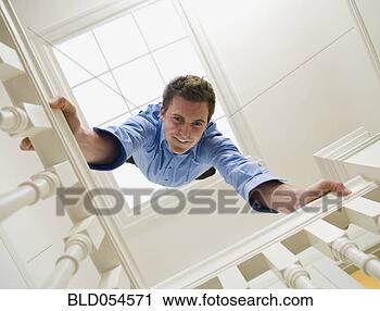 Stock Photography - hispanic businessman 
doing handstand 
on railing. fotosearch 
- search stock 
photos, pictures, 
images, and photo 
clipart