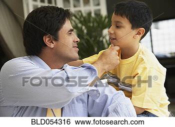Stock Photo - hispanic father 
touching son’s 
chin. fotosearch 
- search stock 
photos, pictures, 
images, and photo 
clipart
