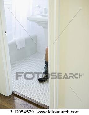 Stock Photograph - hispanic man’s 
knee and pants 
around ankle in 
bathroom. fotosearch 
- search stock 
photos, pictures, 
images, and photo 
clipart