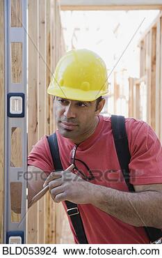 Stock Photo - mixed race male 
construction worker 
using level. fotosearch 
- search stock 
photos, pictures, 
images, and photo 
clipart