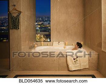 Stock Image - woman relaxing 
in bubble bath. 
fotosearch - search 
stock photos, 
pictures, images, 
and photo clipart