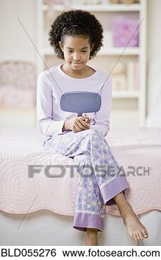 Stock Photo - african girl looking 
in mirror. fotosearch 
- search stock 
photos, pictures, 
images, and photo 
clipart