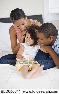Stock Photography - african parents 
smiling at daughter. 
fotosearch - search 
stock photos, 
pictures, images, 
and photo clipart