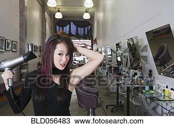 Stock Photo - asian hair stylist 
blow drying hair. 
fotosearch - search 
stock photos, 
pictures, images, 
and photo clipart