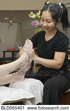 Stock Photography - asian spa technician 
giving massage. 
fotosearch - search 
stock photos, 
pictures, images, 
and photo clipart