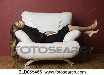 Stock Photo - middle eastern 
woman laying on 
chair. fotosearch 
- search stock 
photos, pictures, 
images, and photo 
clipart