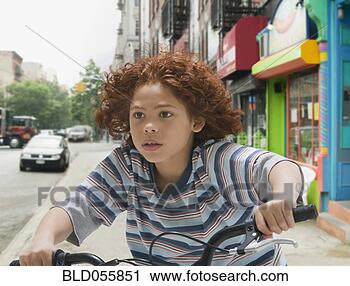 Stock Photography - mixed race boy 
riding bicycle. 
fotosearch - search 
stock photos, 
pictures, images, 
and photo clipart