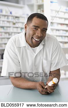 Picture - mixed race male 
pharmacist holding 
medication. fotosearch 
- search stock 
photos, pictures, 
images, and photo 
clipart