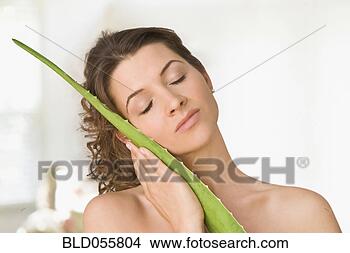 Stock Photo - woman hugging 
aloe leaf. fotosearch 
- search stock 
photos, pictures, 
images, and photo 
clipart