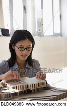 Stock Photo - asian female architect 
building model. 
fotosearch - search 
stock photos, 
pictures, images, 
and photo clipart