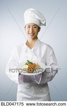 Stock Image - asian female chef 
holding plate 
of food. fotosearch 
- search stock 
photos, pictures, 
images, and photo 
clipart