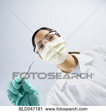 Stock Photography - asian female dentist 
holding dental 
tool. fotosearch 
- search stock 
photos, pictures, 
images, and photo 
clipart