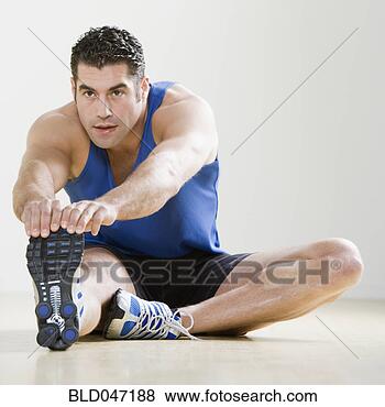 Stock Photo - hispanic man in 
athletic gear 
stretching. fotosearch 
- search stock 
photos, pictures, 
images, and photo 
clipart