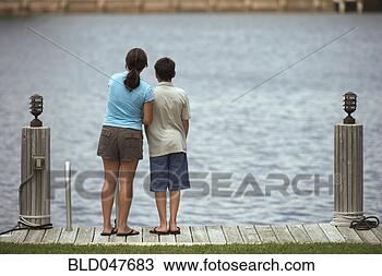 Stock Photo - mixed race brother 
and sister on 
dock. fotosearch 
- search stock 
photos, pictures, 
images, and photo 
clipart