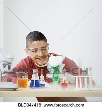 Stock Photo - mixed race teenage 
boy doing science 
experiment. fotosearch 
- search stock 
photos, pictures, 
images, and photo 
clipart