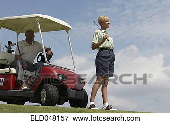 Picture - senior african 
american couple 
with golf cart. 
fotosearch - search 
stock photos, 
pictures, images, 
and photo clipart
