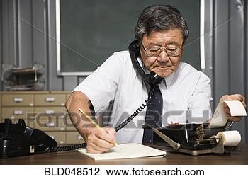 Stock Photo - senior asian businessman 
using old fashioned 
adding machine. 
fotosearch - search 
stock photos, 
pictures, images, 
and photo clipart