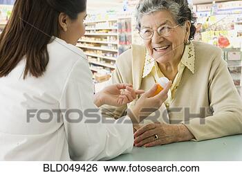 Stock Photo - senior hispanic 
woman discussing 
medication with 
pharmacist. fotosearch 
- search stock 
photos, pictures, 
images, and photo 
clipart