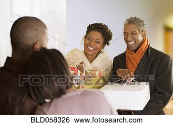 Stock Photo - african couple 
arriving with 
christmas gifts. 
fotosearch - search 
stock photos, 
pictures, images, 
and photo clipart