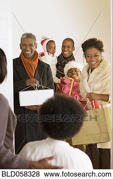 Stock Photo - african family 
arriving with 
christmas gifts. 
fotosearch - search 
stock photos, 
pictures, images, 
and photo clipart