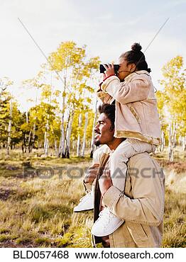 Stock Photo - african girl looking 
through binoculars 
on father’s shoulders. 
fotosearch - search 
stock photos, 
pictures, images, 
and photo clipart