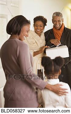Picture - african grandparents 
smiling at granddaughter. 
fotosearch - search 
stock photos, 
pictures, images, 
and photo clipart