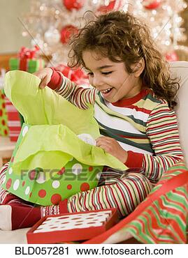 Stock Photography - hispanic girl 
opening gift. 
fotosearch - search 
stock photos, 
pictures, images, 
and photo clipart