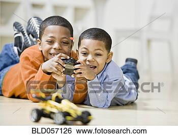 Stock Photo - mixed race brothers 
playing with remote 
control car. fotosearch 
- search stock 
photos, pictures, 
images, and photo 
clipart