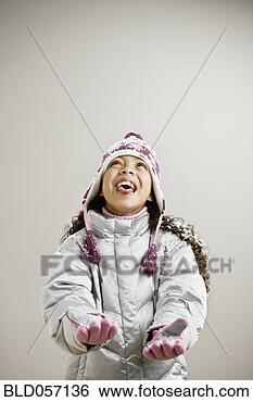 Stock Photo - mixed race girl 
sticking out tongue 
in snow. fotosearch 
- search stock 
photos, pictures, 
images, and photo 
clipart